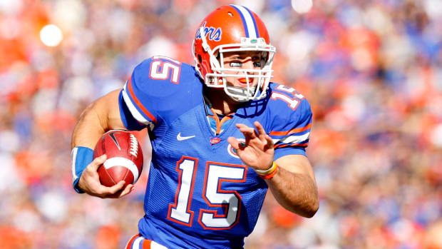 Florida Gators quarterback Tim Tebow on a rushing attempt during a college football game in the SEC.
